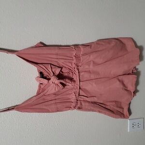 Womans peach colored romper.